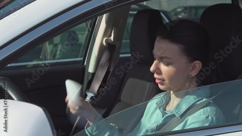 Stressed driver in Traffic jam, a young woman suffering from heat inside the car with a broken air conditioner. Hot weather in summer