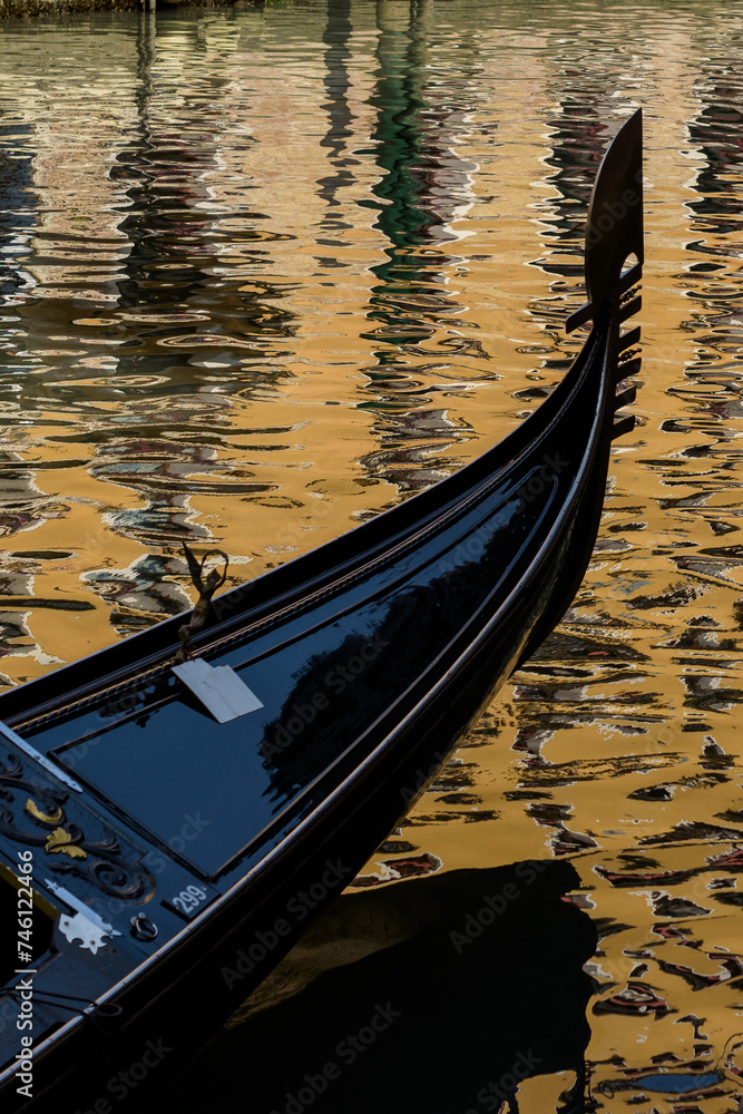 Venice gondola on golden water 
