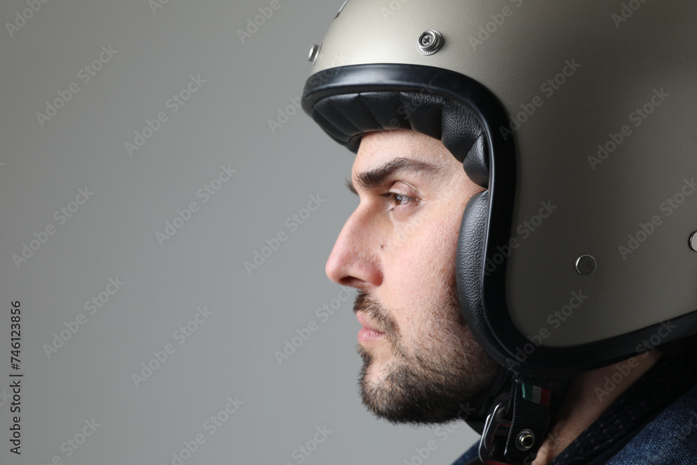 Close-up of bearded man wearing helmet looking aside posing indoor. Close-up of bearded man wearing helmet looking aside posing indoor.