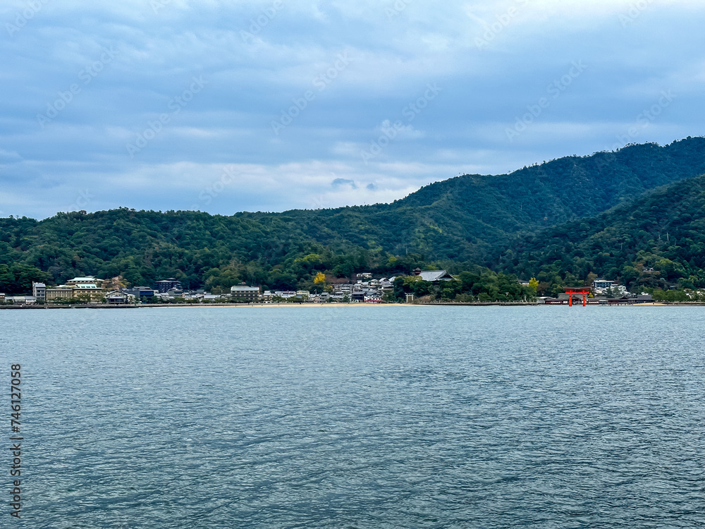Scenery of Miyajima Island and the Hiroshima Bay Inland Sea. Miyajima can be reached by regular ferry from main island. Cloudy autumnal day. Itsukushima is part of the city of Hatsukaichi in Hiroshima