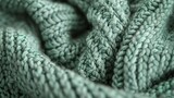 View from above reveals a lush mint green moss stitch knit, highlighting dense, textured weave.