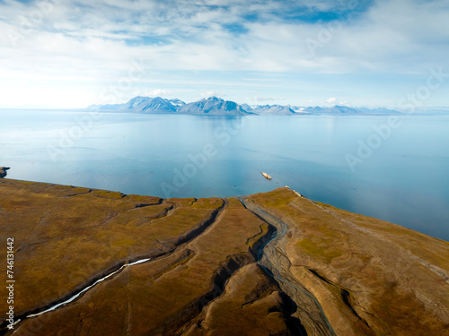 drone footage of breathtaking footage of wild nature in Svalbard, mountains and rivers surrounded by freezing winter and untouched nature, footage of a massive river surrounded by hills, svalbard