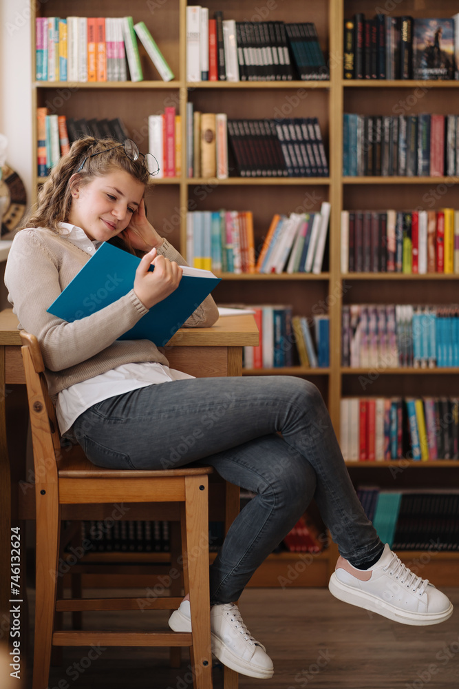 A relaxed teenage girl, seated with one leg over the other, writes in a notebook, studying in a casual setting A relaxed teenage girl, seated with one leg over the other, writes in a notebook, studying in a casual setting