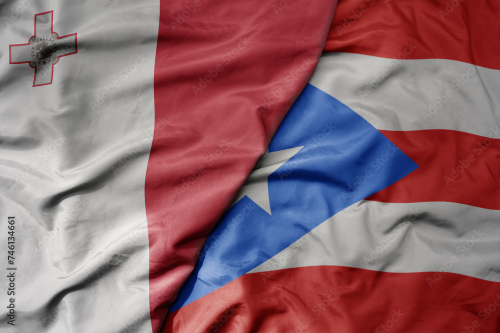 big waving national colorful flag of puerto rico and national flag of malta.