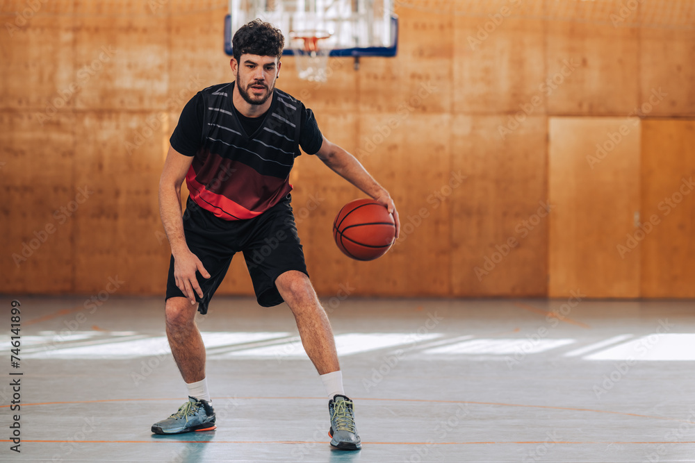 Professional basketball player in action dribbling a ball on court.