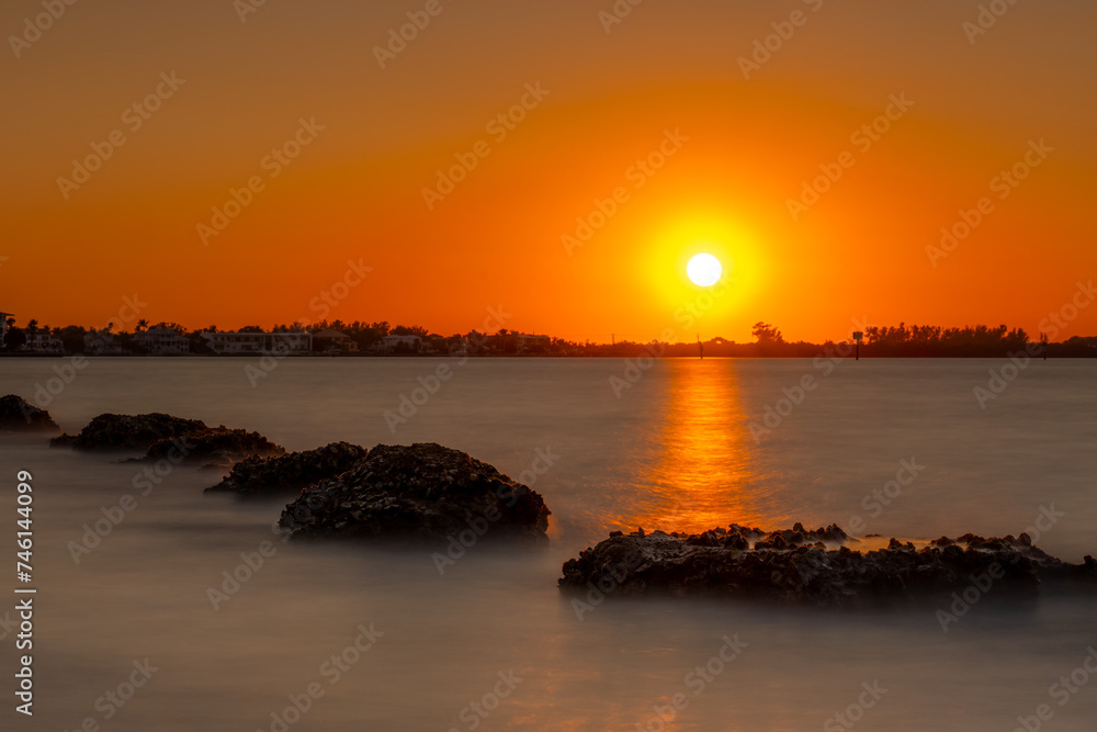 Orange sunset at Siesta Key beach with sunshine, Sarasota, Florida
