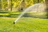 Automatic sprinklers for watering grass. the lawn is watered in summer. convenient for home