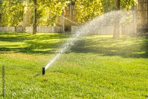 Automatic sprinklers for watering grass. the lawn is watered in summer. convenient for home