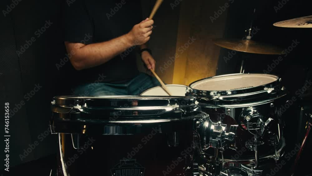 Expressive drummer young man professionally playing on dums in studio room close-up. Rock metall music artist Expressive drummer young man professionally playing on dums in studio room close-up. Rock metall music artist