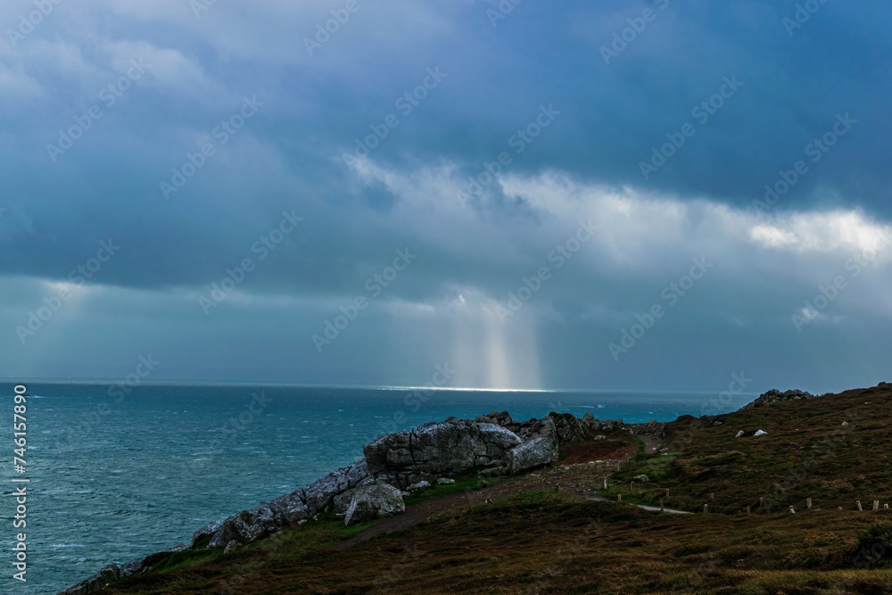 storm clouds and sunbeams over the sea