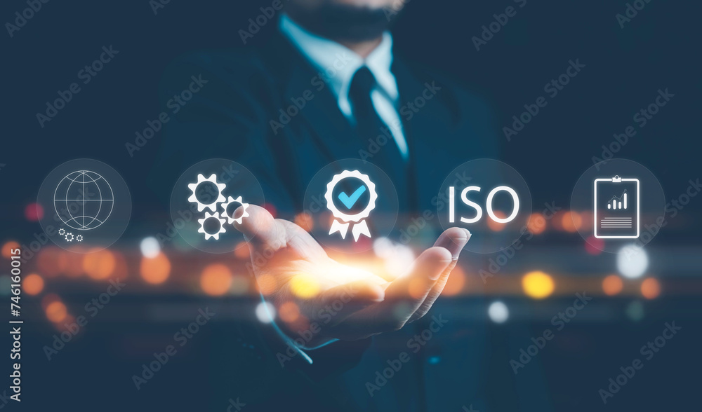 © pornnipa - ISO standards quality control, assurance and warranty business technology concept. Touching on screen with ISO and globe icons on smart background. ISO Standard certification. Modern ISO banner.