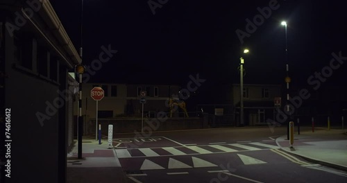 Pedestrian road crossing Belisha Beacon flashing orange globe lights walking stabilized photo