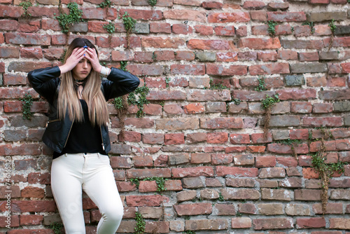 Portrait stressed sad young woman standing outdoors. Beauty strong depressed unhappy woman. City life style stress.