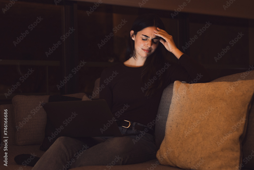 Obraz premium Stressed woman at late night having strong terrible headache attack after computer laptop study, sleepy exhausted girl suffering from chronic migraine massaging temples to relieve head ache tension.