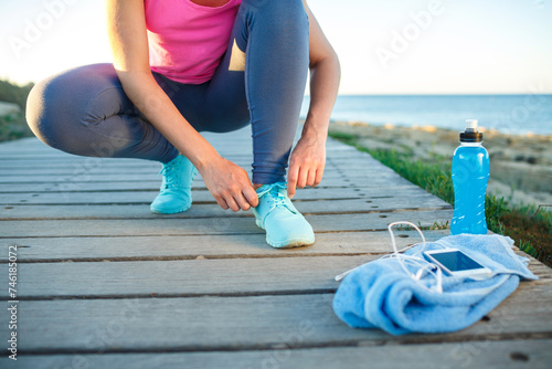 Running shoes - woman tying shoe laces photo