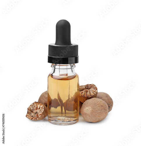 Nutmeg essential oil and nuts isolated on white