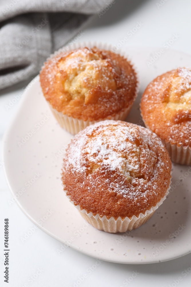 Delicious sweet muffins on white table, closeup