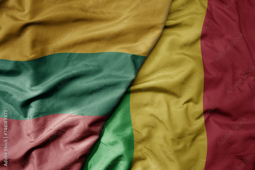 big waving national colorful flag of mali and national flag of lithuania .