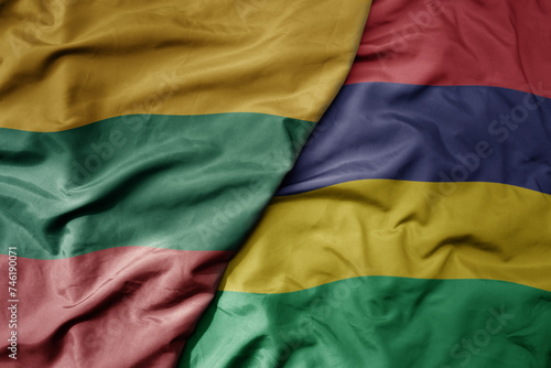 big waving national colorful flag of mauritius and national flag of lithuania .