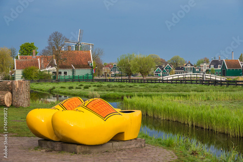 Zaanse Schans, Netherlands - May 1, 2023: Dutch Windmill and traditional house with wood shoes in village