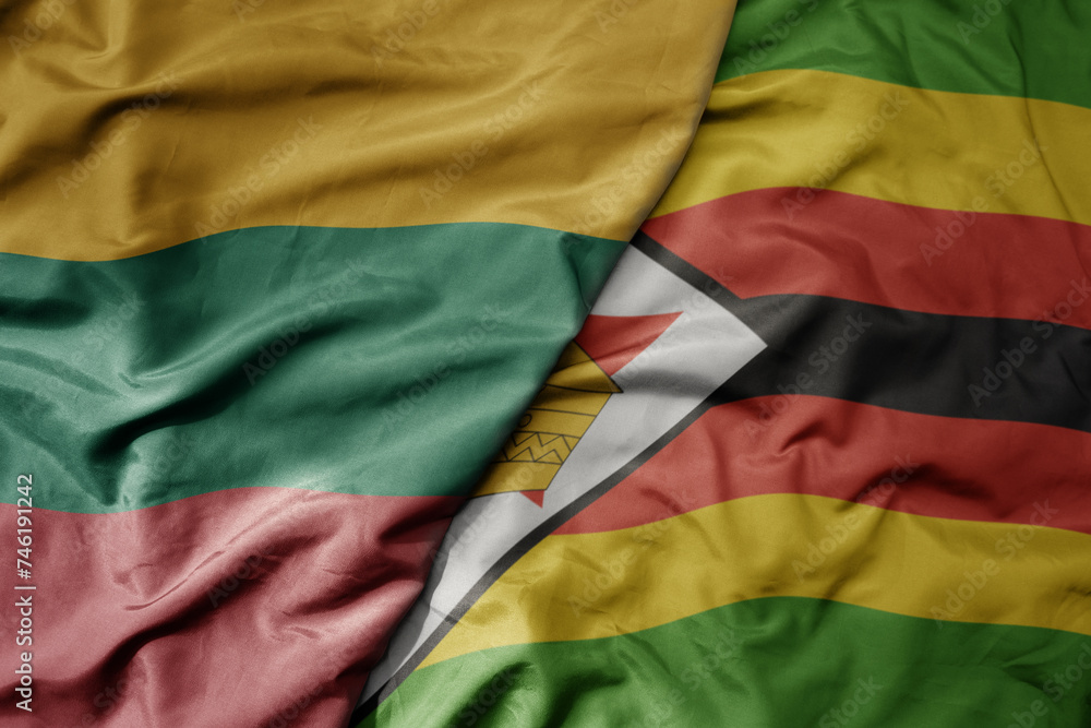 big waving national colorful flag of zimbabwe and national flag of lithuania . big waving national colorful flag of zimbabwe and national flag of lithuania .