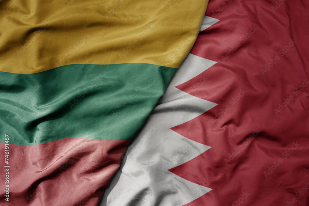 big waving national colorful flag of bahrain and national flag of lithuania .