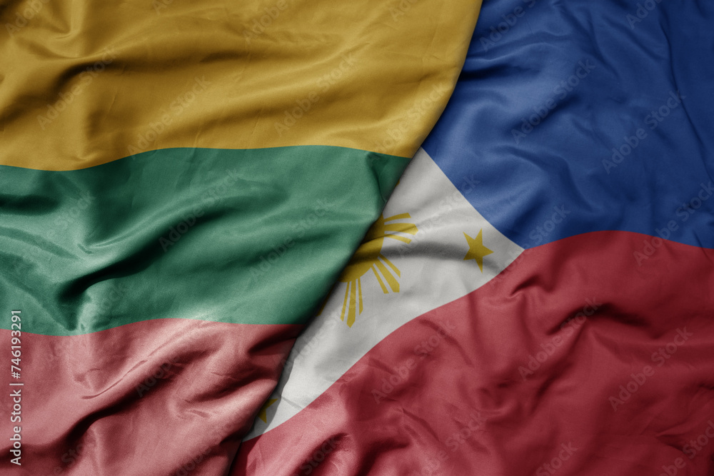 big waving national colorful flag of philippines and national flag of lithuania .