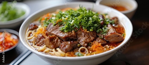A bowl filled with Hong Kong style beef brisket rice noodles, featuring tender beef brisket, fragrant rice, and traditional noodles, accompanied by a variety of vegetables.