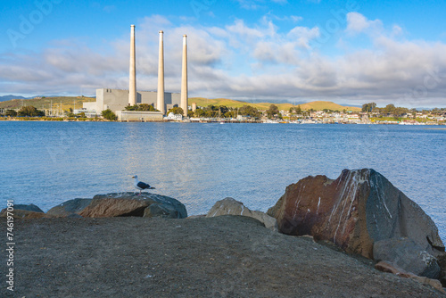 Rocky beach and old power plants whose three large smokestacks can be seen from anywhere in Morro Bay. Morro Bay State Park, California Central Coast © Hanna Tor