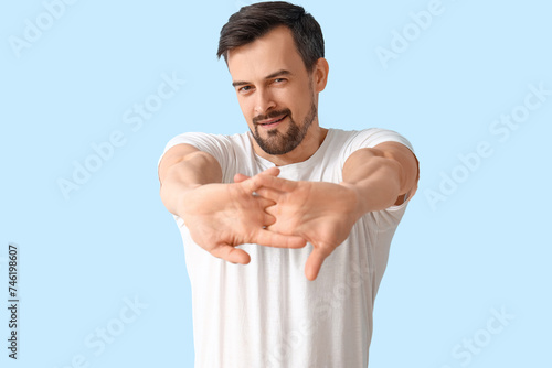 Handsome man stretching on ...