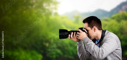 Photographer hold camera taking pictures outdoor