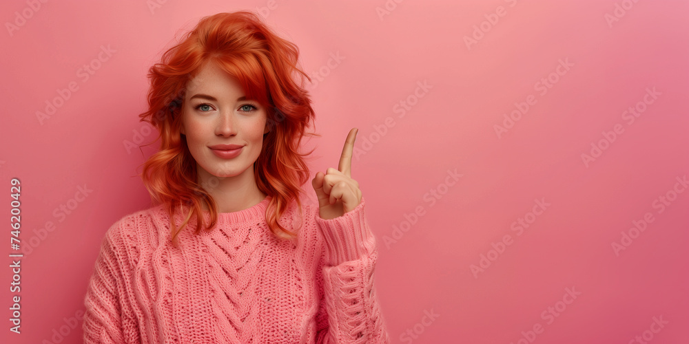 Pretty redhead young lady with eyeglasses gesturing with index finger to the side, dressed in a cotton candy pink knitted sweater, posed solo against a vibrant pink studio background Pretty redhead young lady with eyeglasses gesturing with index finger to the side, dressed in a cotton candy pink knitted sweater, posed solo against a vibrant pink studio background