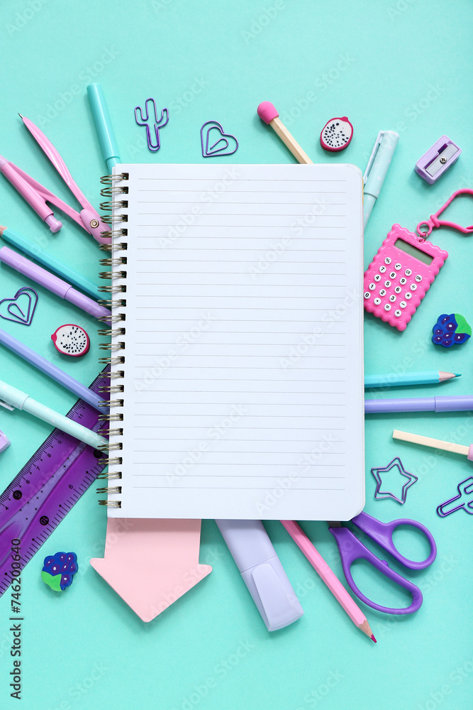 Notebook with different stationery supplies on blue background Notebook with different stationery supplies on blue background