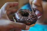  child mouth eating chocolate donuts 