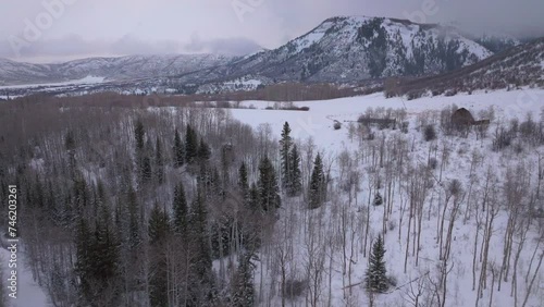 Winter red barn Aspen Snowmass Pitkin county wilderness aerial drone Rocky Mountains Colorado Basalt Carbondale Sopris Maroon Bells Ashcroft Independence Pass cloudy foggy snowy morning forward motion photo