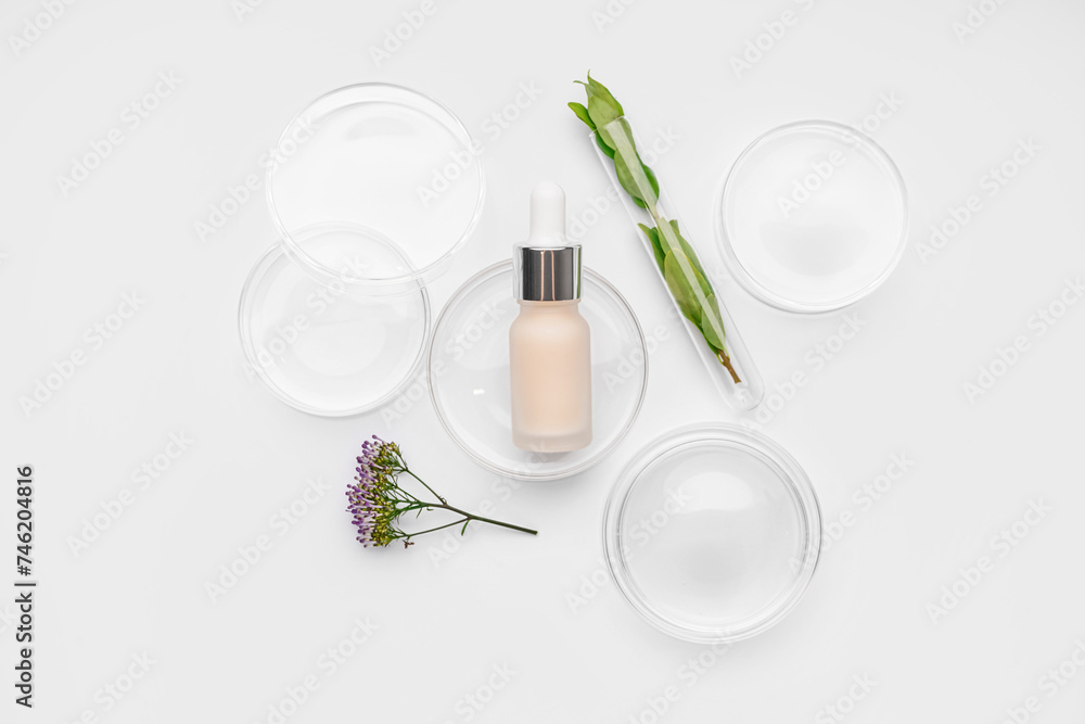 Petri dishes with herbs and bottle of cosmetic product on white background Petri dishes with herbs and bottle of cosmetic product on white background