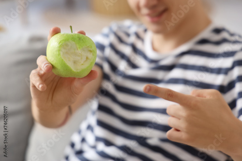 Young man with tasty apple ...