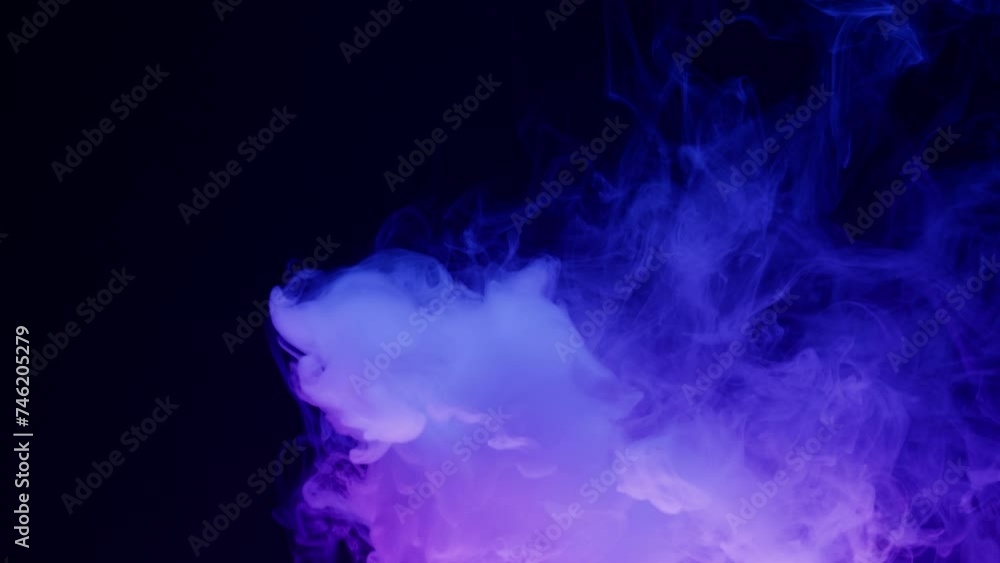 Smoke texture on black background in blue neon light. Smoking, steam clouds of vapour close-up. Burning, fog. Smoke texture on black background in blue neon light. Smoking, steam clouds of vapour close-up. Burning, fog.