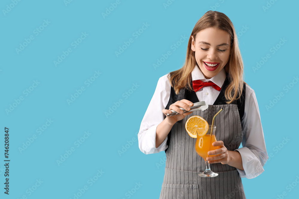 Female bartender with ice cube and cocktail on blue background Female bartender with ice cube and cocktail on blue background