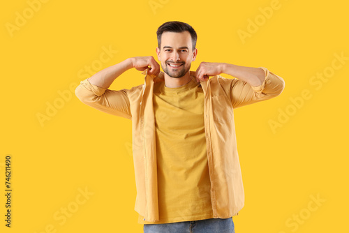 Young man in shirt on yello...