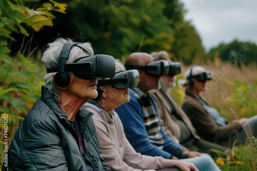 A Group of Seniors Elderly Men and Women from Diverse Ethnicities Wearing VR Headset. Enjoying Virtual Reality and Nature Experience in Outside Forest Background. Horizontal Photo (3:2) 