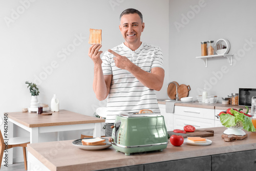 Middle-aged man pointing at...