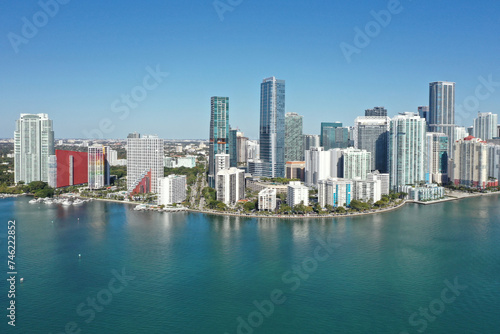 Aerial image of waterfront residential buildings in Brickell neighborhood of Miami  Florida reflected in calm water of Biscayne Bay on sunny morning.