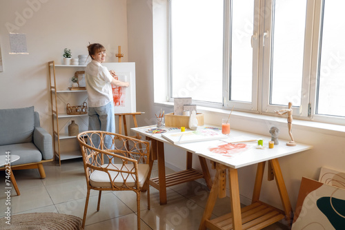 Female artist with painting...