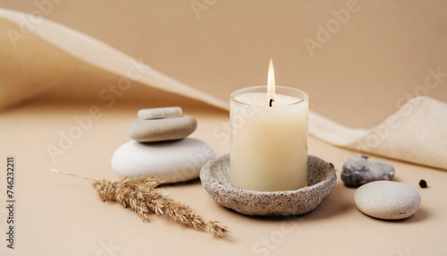 spa still life with candles and towel  Aroma candle on beige background. Warm aesthetic composition with stones. Cozy home comfort  relaxation and wellness concept. Interior decoration mockup