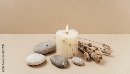 christmas candle and decorations wallpaper Aroma candle on beige background. Warm aesthetic composition with stones. Cozy home comfort  relaxation and wellness concept. Interior decoration mockup