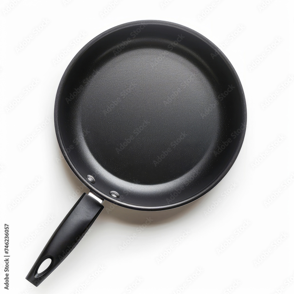 Black non-stick frying pan with a simple design and a heat-resistant handle, isolated on a white background. Black non-stick frying pan with a simple design and a heat-resistant handle, isolated on a white background.