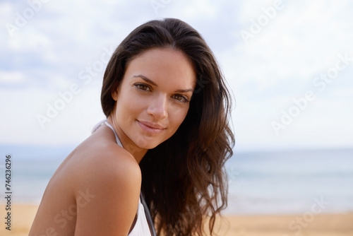 Beach, smile and portrait of woman in nature on tropical vacation, adventure or holiday. Happy, travel and young female person with positive attitude by ocean on summer weekend trip by island.