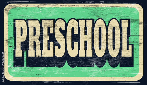 Aged and worn vintage preschool sign on wood