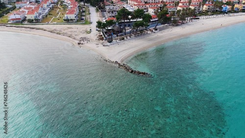 Aerial drone view of Pefkohori beach in Halkidiki, Greece demonstrating the crystal clear blue sea water photo
